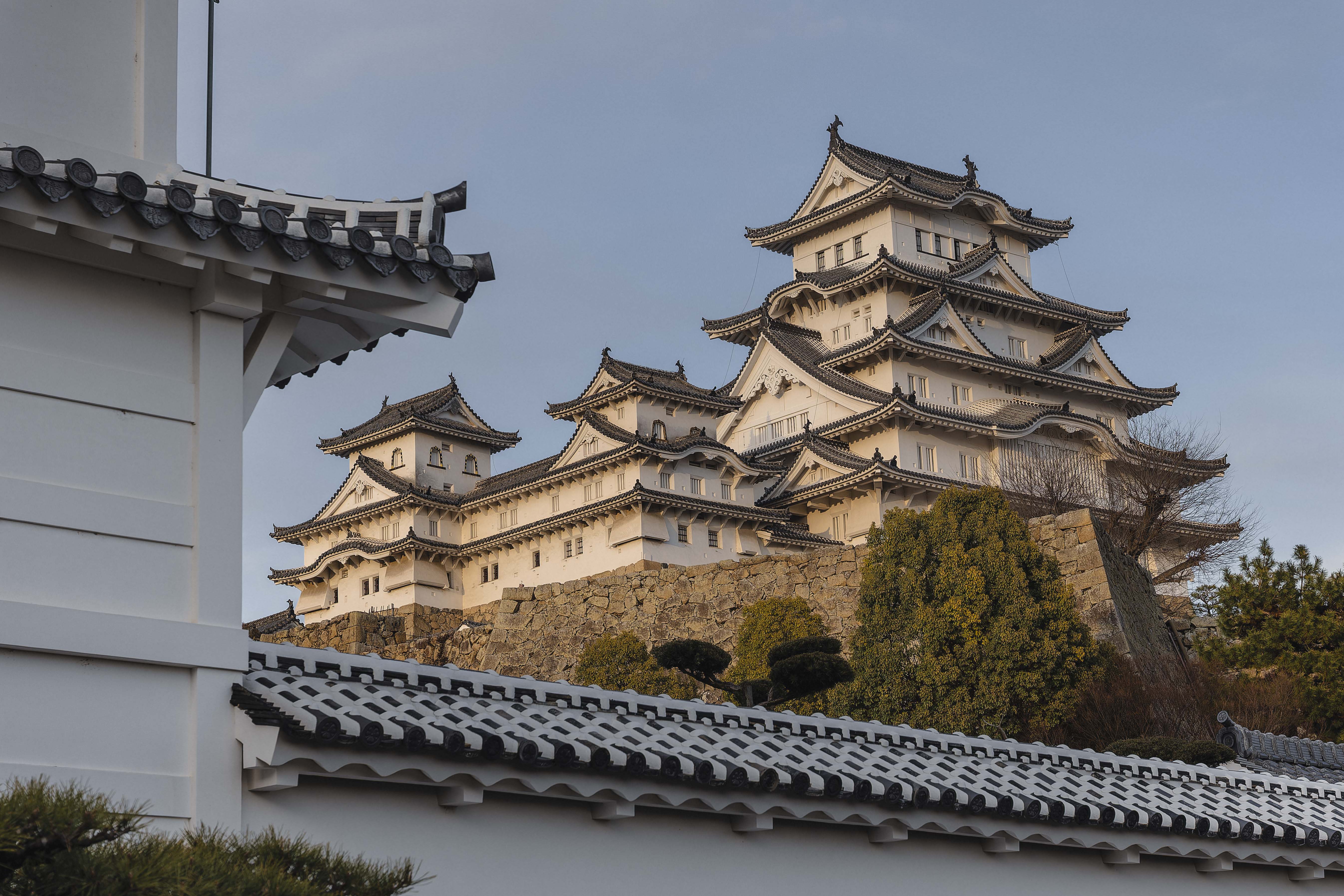 Himeji Castle — View 30: Framed by Stone and Tile in the Setting Sun (from Near the stone wall east of Hishi no Mon, spring afternoon)